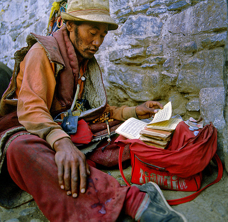 Itinerant Tibetan Lama Reading Holy Text near Potala, Lhasa