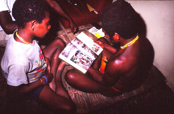 Dan Men Looking at The National Geographic