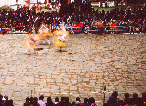 Crowds Look on As Dancers Twirl, Wangdi Festical